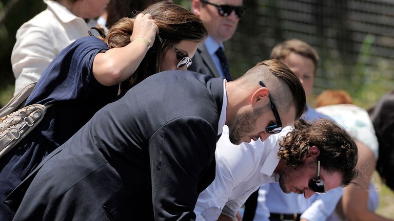 Mourners sign Books of Condolence ahead of the service.
