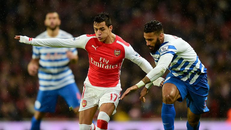 Arsenal's Alexis Sanchez (left) and Queens Park Rangers' Armand Traore battle for the ball during the Barclays Premier League match at the Emirates Stadium