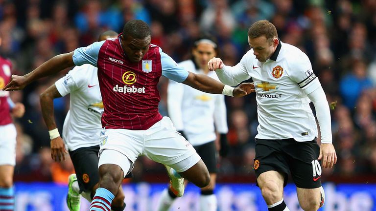 Jores Okore holds off a challenge from Wayne Rooney