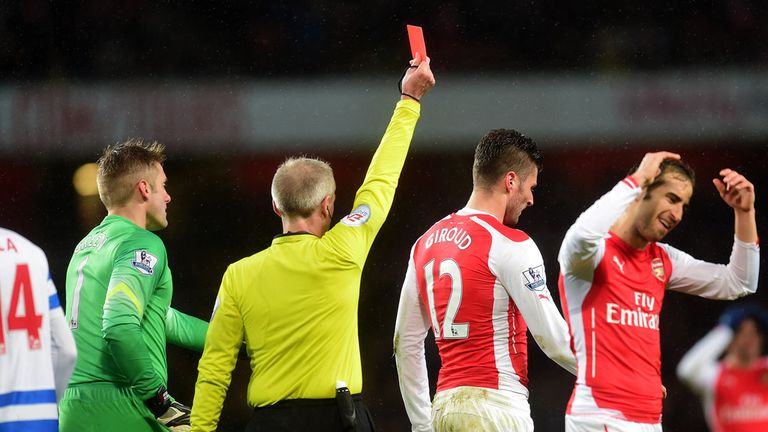 Arsenal's Olivier Giroud is shown a red card by referee Martin Atkinson during the Barclays Premier League match at the Emirates Stadium, London.