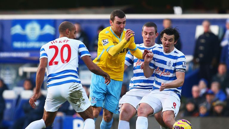James McArthur of Crystal Palace attempts to beat Karl Henry, Richard Dunne and Joey Barton of QPR at Loftus Road.