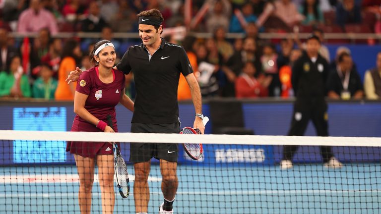 DELHI, INDIA - DECEMBER 07:  Roger Federer and Sania Mirza of the Indian Aces at the net after their victory against Nick Kyrgios and Daniela Hantuchova of