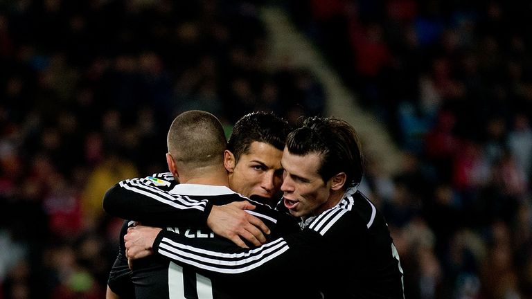 Cristiano Ronaldo (2ndL) of Real Madrid CF celebrates scoring their third goal with teammate Karim Benzema (L) and Gareth Bale