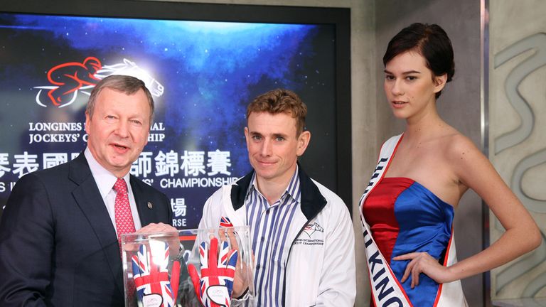 A delighted Ryan Moore receives commemorative jockeys' gloves in his national colours from HKJC CEO Winfried Engelbrecht-Bresges.