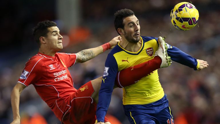 Arsenal's Santi Cazorla (right) and Liverpool's Philippe Coutinho (left) battle for the ball during the Barclays Premier League match at Anfield, Liverpool