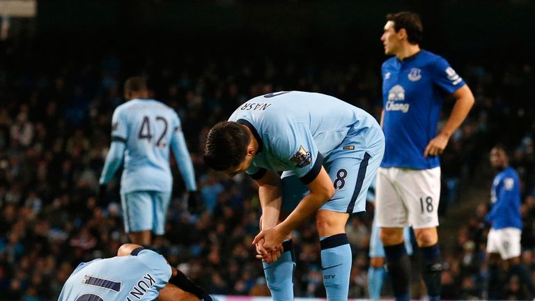 Manchester City's Argentinian striker Sergio Aguero (L) lies injured during the English Premier League football match between Manchester City and Everton