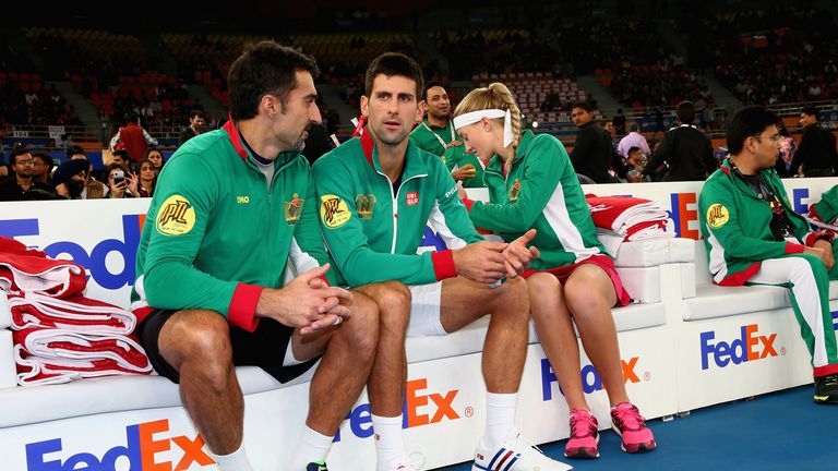 Novak Djokovic of the UAE Royals makes his debut as his he sits on the team bench talking to Nenad Zimonjic before their match