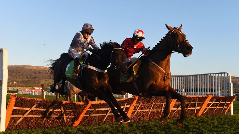 CHELTENHAM, ENGLAND - DECEMBER 13:  The New One riden by jockey Sam Twiston-Davies (R) jumps the final hurdle with Vaniteux riden by Barry Geraghty to win 