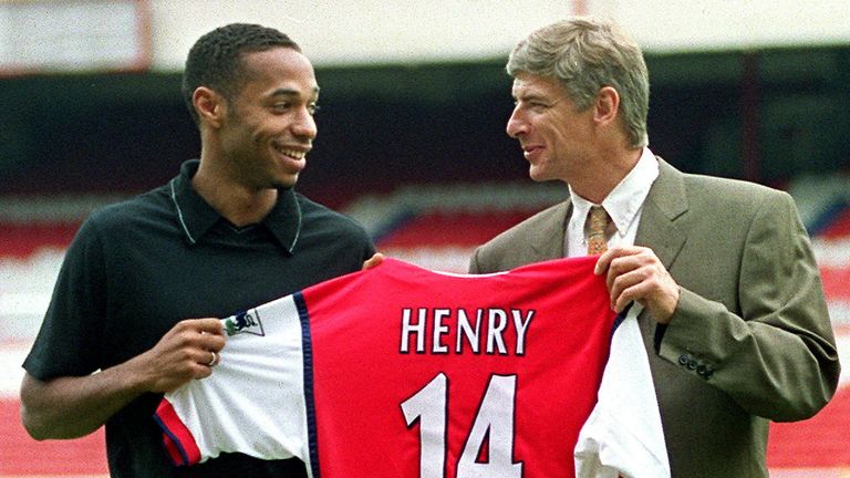 Henry holds up his shirt with Arsene Wenger after signing in August, 1999.