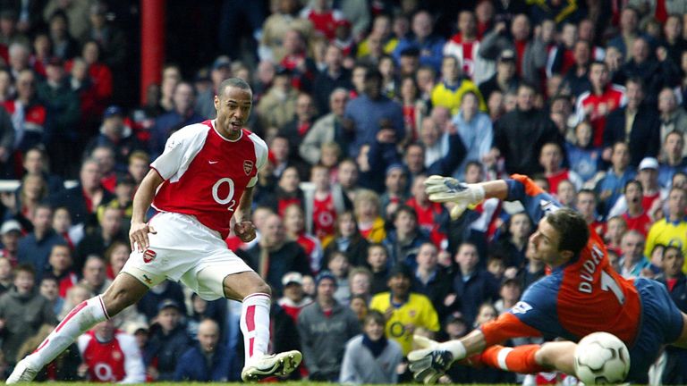 Arsenal's Thierry Henry (L) puts the ball beyond Liverpool's Jerzy Dudek  for his second goal of the day during the 4-2 win at Highbury in April 2004