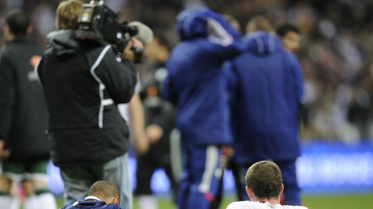 Henry sits with Irish defender Richard Dunne after his infamous 'handball' helped France qualify for the 2010 World Cup.