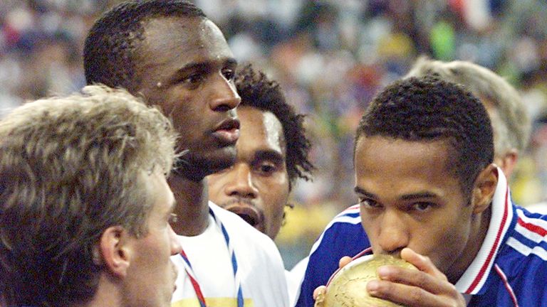 World champion! Henry kisses the World Cup after victory over Brazil in the 1998 final.