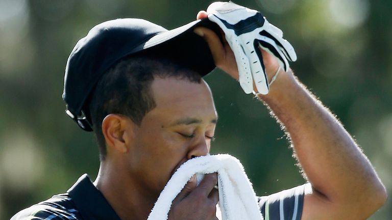 WINDERMERE, FL - DECEMBER 04:  Tiger Woods wipes his face on the third tee during the first round the Hero World Challenge at the Isleworth Golf & Country 