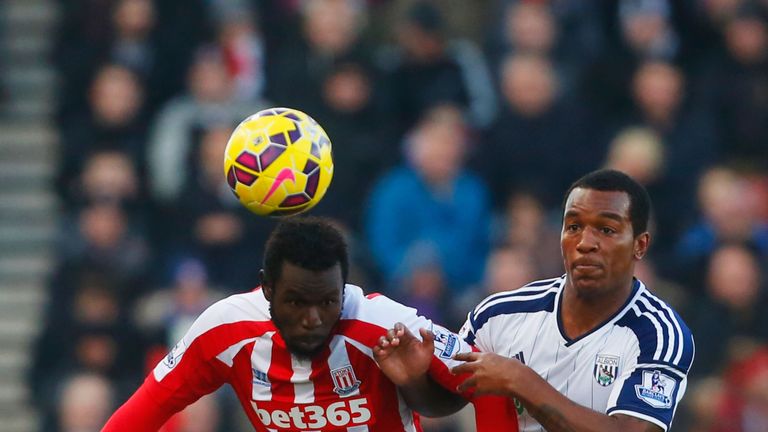 STOKE ON TRENT, ENGLAND - DECEMBER 28:  Mame Biram Diouf of Stoke City battles with Andre Wisdom of West Bromwich Albion during the Barclays Premier League