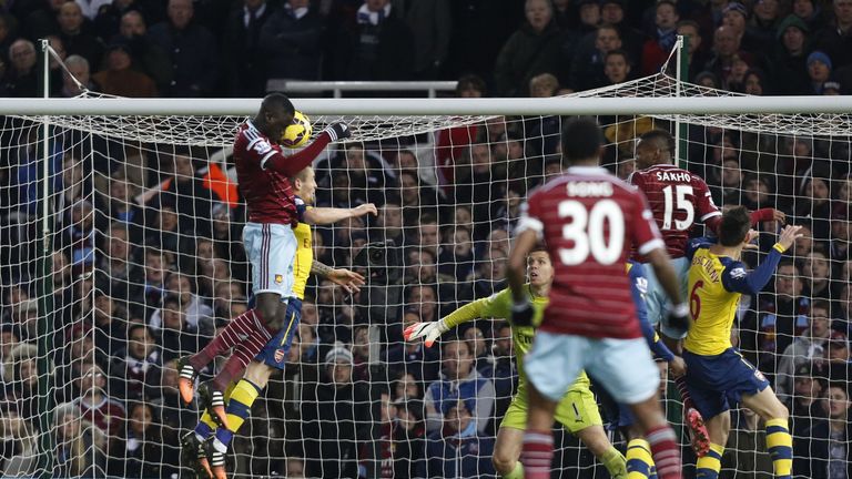 West Ham United's Senegalese midfielder Cheikhou Kouyate jumps highest to pull a goal back against Arsenal.