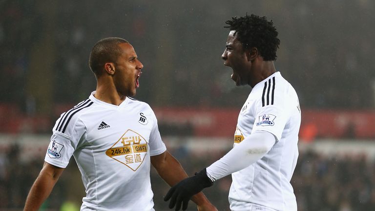 Swansea's Wilfried Bony celebrates his equaliser with Wayne Routledge... it's 1-1