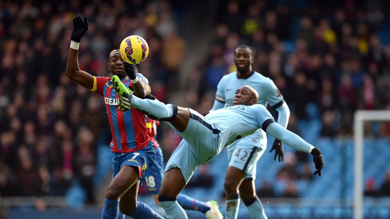 Crystal Palace's Yannick Bolasie (L) vies with defender Eliaquim Mangala (R) during the match between  at the Etihad Stadium