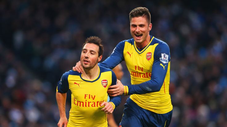 MANCHESTER, ENGLAND - JANUARY 18:  Santi Cazorla of Arsenal (L) celebrates with Olivier Giroud as he scores their first goal from a penalty 