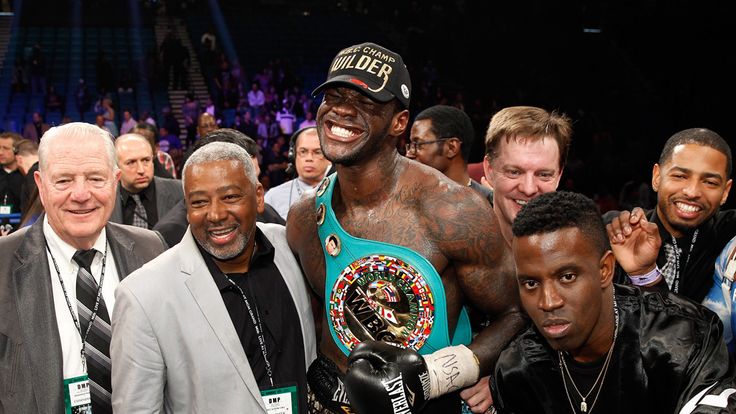 Deontay Wilder poses with members of his camp 