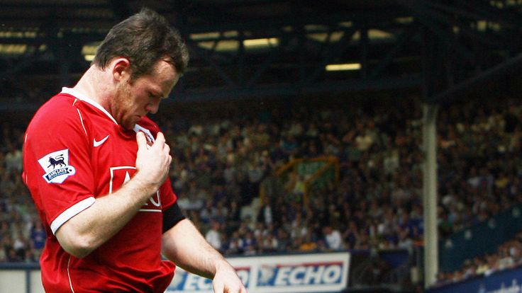 Wayne Rooney of Manchester United kisses the badge on his shirt after scoring against Everton 