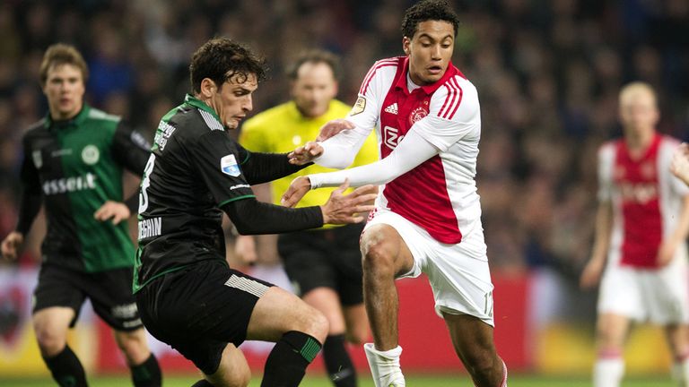 Ajax's Jairo Riedewald (C) vies for the ball with FC Groningen's Eric Botteghin
