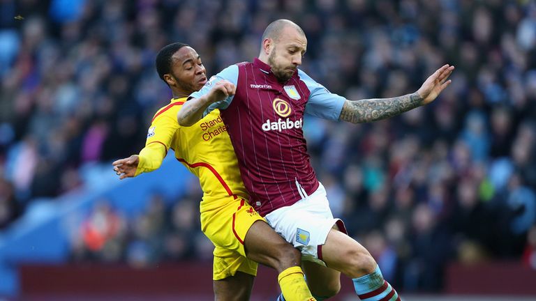 Alan Hutton is tackled by Raheem Sterling 