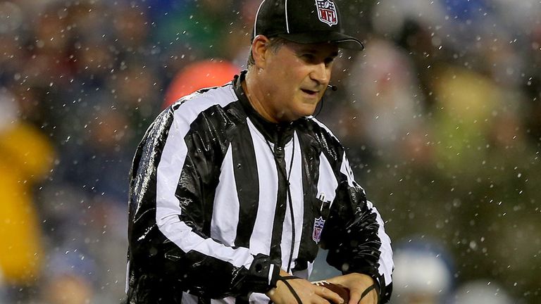 FOXBORO, MA - JANUARY 18:  Umpire Carl Paganelli #124 holds a ball on the field after a play during the 2015 AFC Championship Game between the New England 