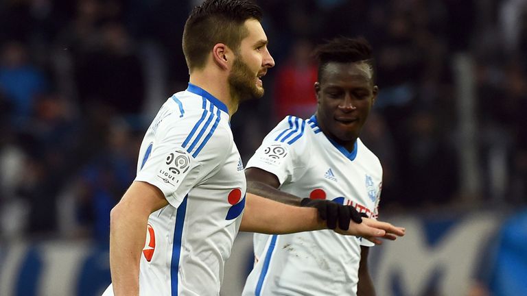 Marseille's French forward Andre-Pierre Gignac is congratulated by Marseille's French defender Benjamin 