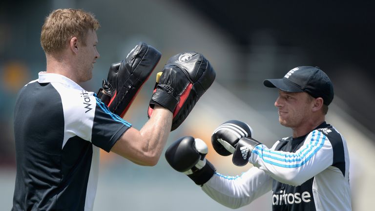 BRISBANE, AUSTRALIA - JANUARY 18:  Former England cricketer Andrew Flintoff holds pads as Jos Buttler of England boxes ahead of a nets session at The Gabba