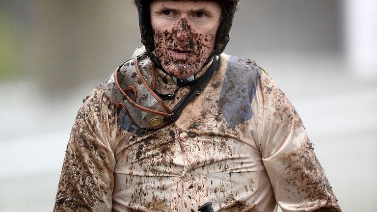 Jockey Tony McCoy is lead into the winner's enclopsure on Aurore D'Estruval after winning the 32Red.com Mares' Hurdle during 32Red Day at Sandown Park Race