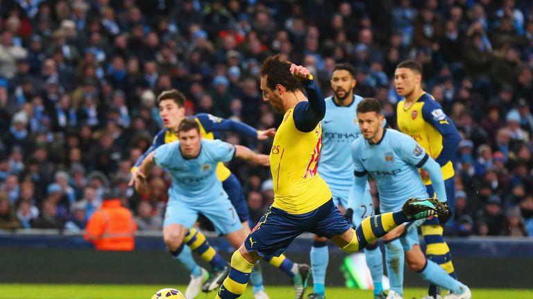 Santi Cazorla of Arsenal scores their first goal from a penalty against Man City