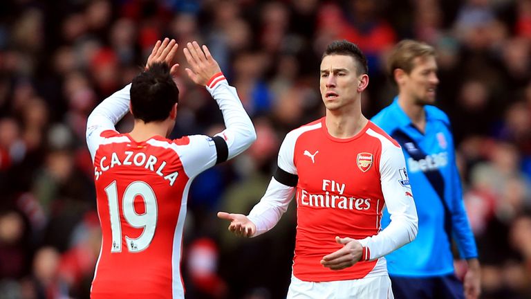 Arsenal's Laurent Koscielny celebrates scoring the opening goal of the game with Santi Cazorla