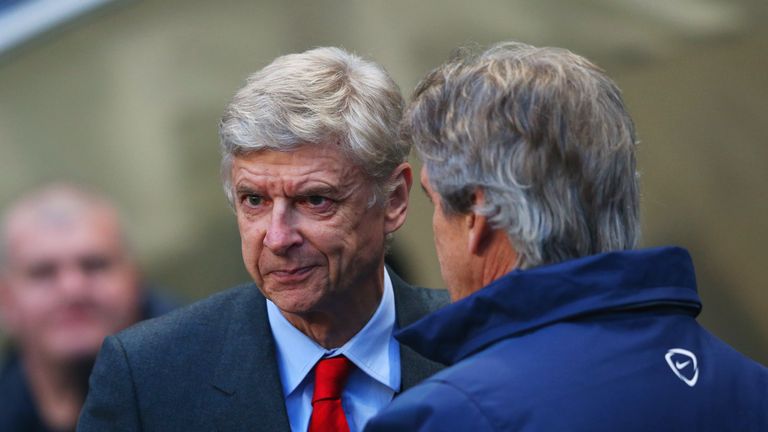 Manuel Pellegrini manager of Manchester City and Arsene Wenger manager of Arsenal shake hands 