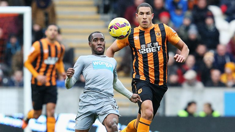 HULL, ENGLAND - JANUARY 31: Vurnon Anita of Newcastle United is closed down by Jake Livermore of Hull City during the Barclays Premier League match between