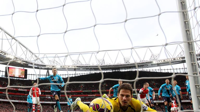 Asmir Begovic fails to stop the ball crossing the line as Alexis Sanchez (not pictured) of Arsenal scores his team's third goal from a freekick.