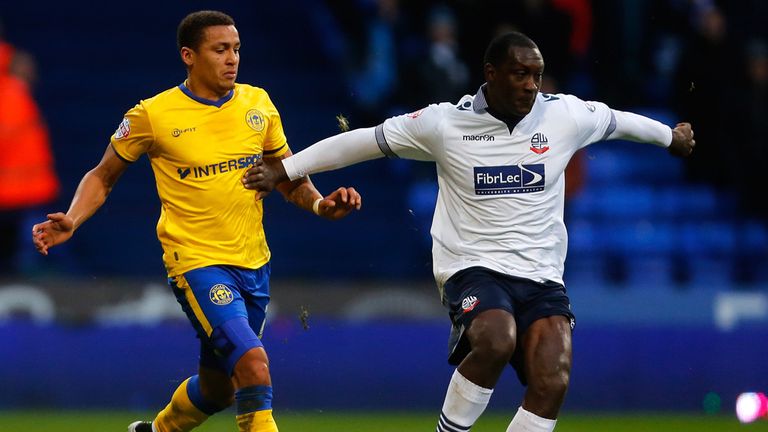 Emile Heskey (R) of Bolton in action with James Tavernier of Wigan