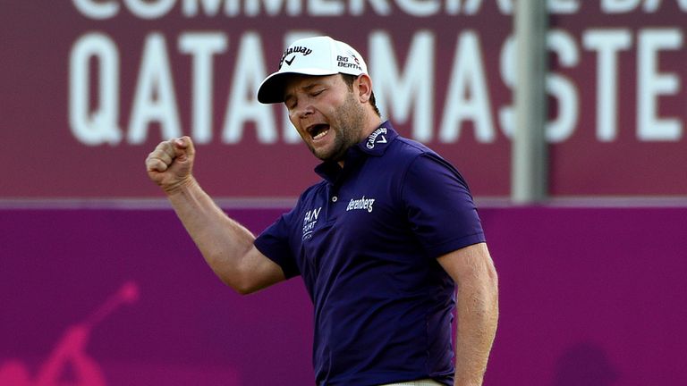 Branden Grace of South Africa celebrates his birdie on the eighteenth green during the final round of the Commercial Bank Qatar Masters