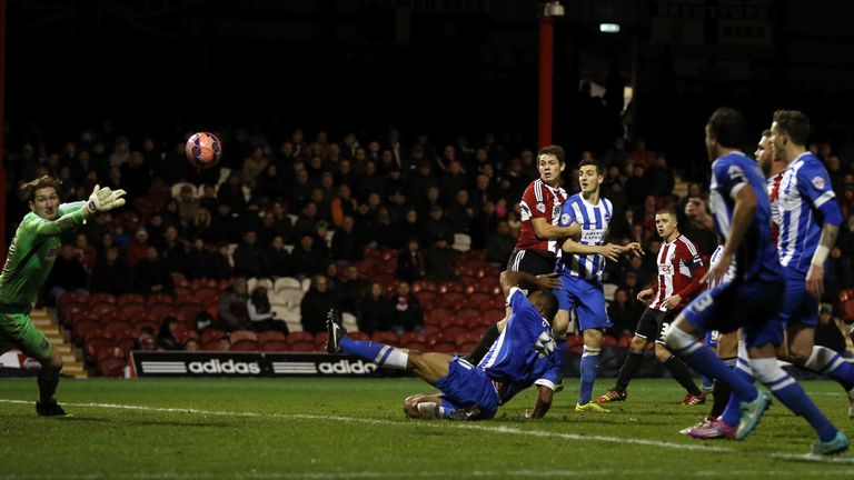 Lewis Dunk (4th L) of Brighton & Hove Albion scores the opener during the FA Cup Third Round match between Brentford v Brighton & Hove Albion