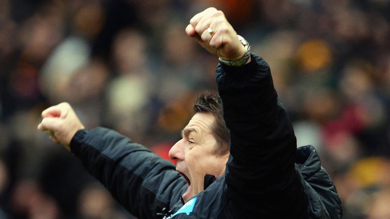 HULL, ENGLAND - JANUARY 31:  John Carver, manager of Newcastle United celebrates his team's third goal during the Barclays Premier League match between Hul