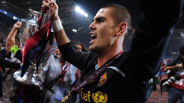 Barcelona goalkeeper Victor Valdes lifts the trophy as he celebrates winning the UEFA Champions League Final after beating Manchester United
