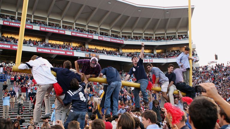 Fans of the Ole Miss Rebels hang on the goalpost while celebrating the victory over the Alabama Crimson Tide 