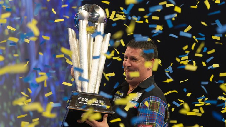 Gary Anderson celebrates with the Sid Waddell trophy after defeating Phil Taylor during the William Hill World Darts Championship at Alexandra Palace, Lond