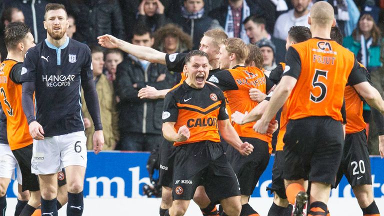 Dundee United players celebrate their third goal in the derby