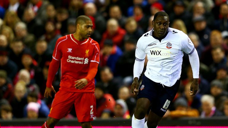 Emile Heskey of Bolton Wanderers runs with the ball past Glen Johnson and Mamadou Sakho of Liverpool 