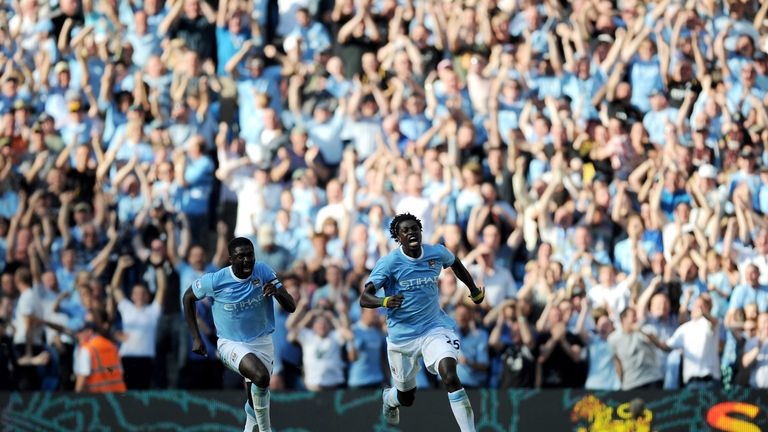 Emmanuel Adebayor of Manchester City celebrates with team-mate Kolo Toure against Arsenal 2009