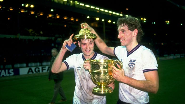 23 Apr 1986:  Glen Hoddle and Terry Butcher of England hold the trophy after a match against Scotland at Wembley Stadium in London.