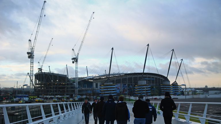 MANCHESTER, ENGLAND - JANUARY 18:  Fans walk to the stadium prior to the Barclays Premier League match between Manchester City and Arsenal at Etihad Stadiu