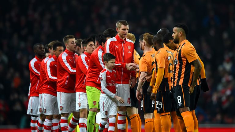 The Arsenal and Hull City players shake hands before the FA Cup Third Round match at the Emirates Stadium