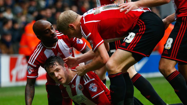 Marc McNulty of Sheffield United celebrates with team mates as he scores their first goal during the FA Cup Third Round