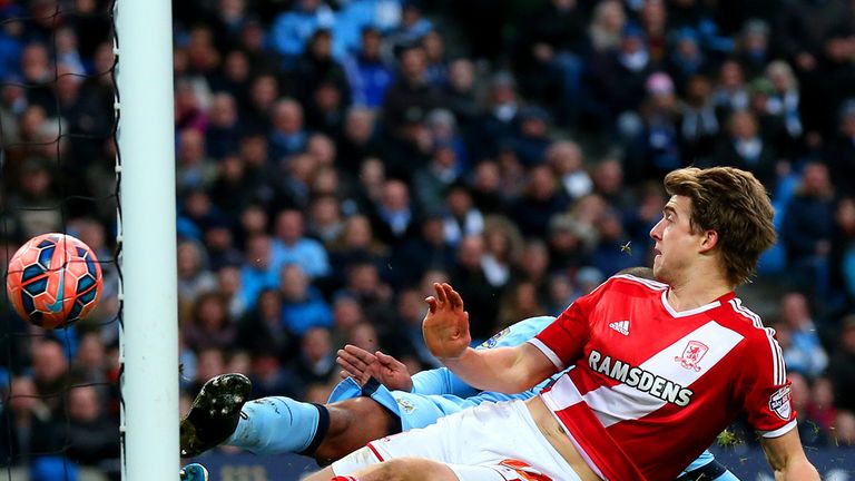 Man City's Fernando attempts to clear the ball but it rebounds off Patrick Bamford and into the net